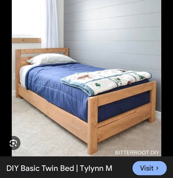 Finished twin bed with blue comforter in a home setting
